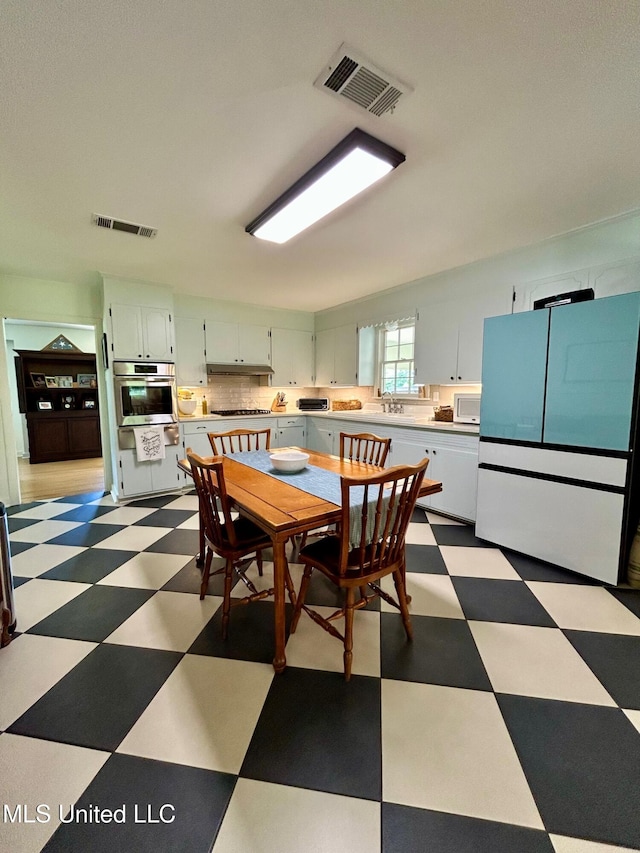 308 College St, Carthage, MS 39051 - dining room with tile patterned floors and visible vents