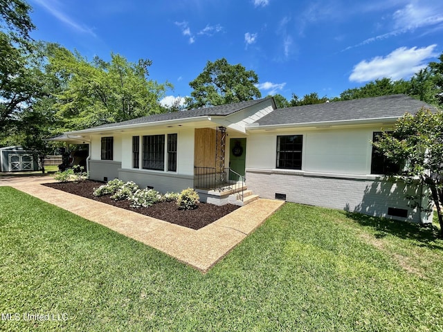 308 College St, Carthage, MS 39051 - single story home with a front lawn, brick siding, a shingled roof, a storage shed, and an outbuilding
