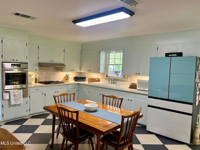 308 College St, Carthage, MS 39051 - kitchen featuring a sink, dark floors, stainless steel appliances, visible vents, and a warming drawer