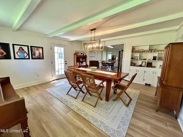308 College St, Carthage, MS 39051 - dining area with an inviting chandelier, baseboards, light wood finished floors, and beam ceiling
