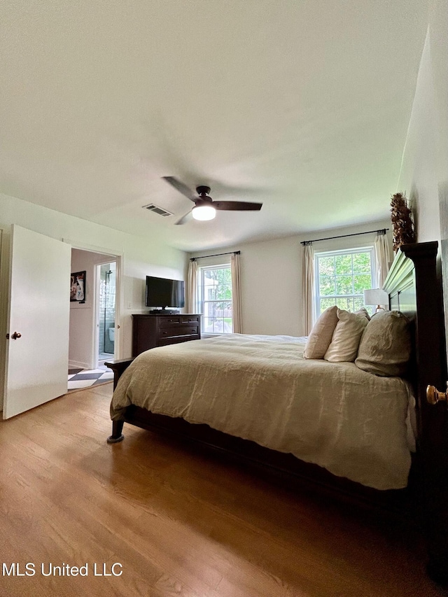 308 College St, Carthage, MS 39051 - bedroom featuring visible vents, ceiling fan, wood finished floors, and multiple windows