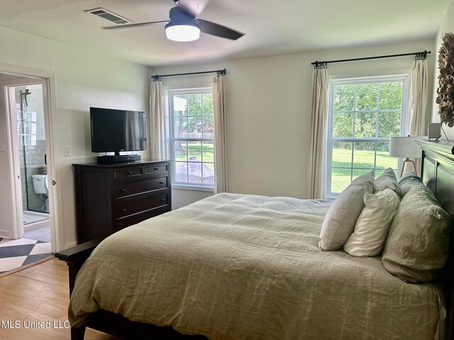 308 College St, Carthage, MS 39051 - bedroom featuring multiple windows, a ceiling fan, wood finished floors, and visible vents
