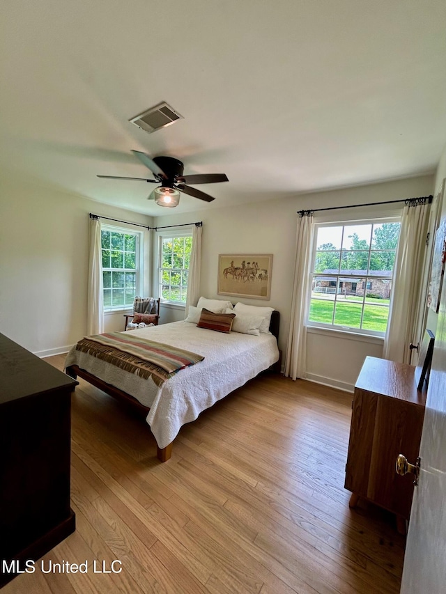 308 College St, Carthage, MS 39051 - bedroom with visible vents, baseboards, ceiling fan, and wood finished floors