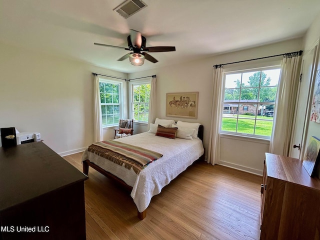308 College St, Carthage, MS 39051 - bedroom with visible vents, baseboards, wood finished floors, and multiple windows