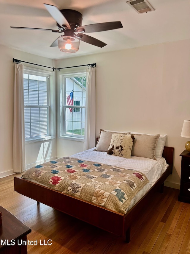 308 College St, Carthage, MS 39051 - bedroom with visible vents, baseboards, ceiling fan, and wood finished floors