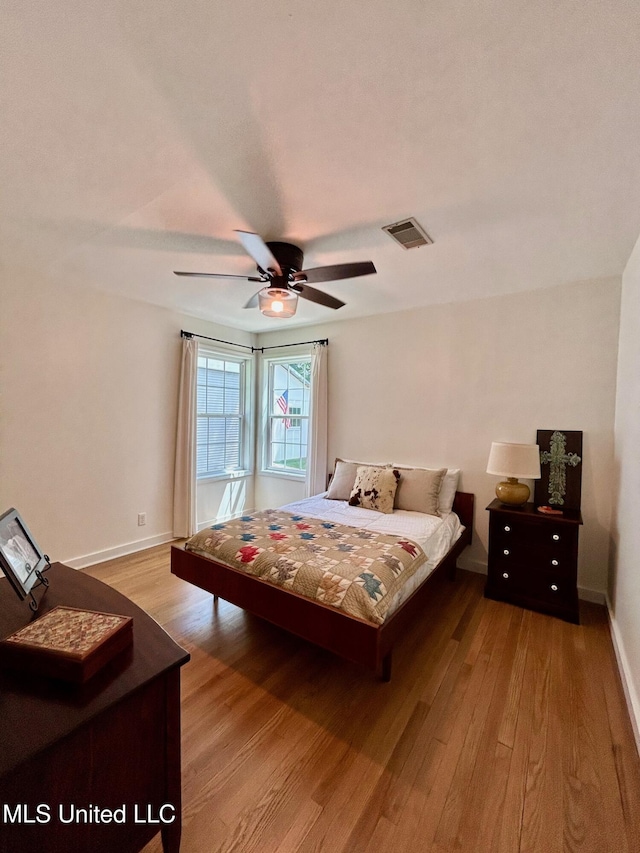 308 College St, Carthage, MS 39051 - bedroom featuring baseboards, visible vents, ceiling fan, and light wood-type flooring