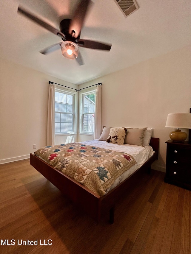 308 College St, Carthage, MS 39051 - bedroom featuring baseboards, a ceiling fan, wood finished floors, and visible vents