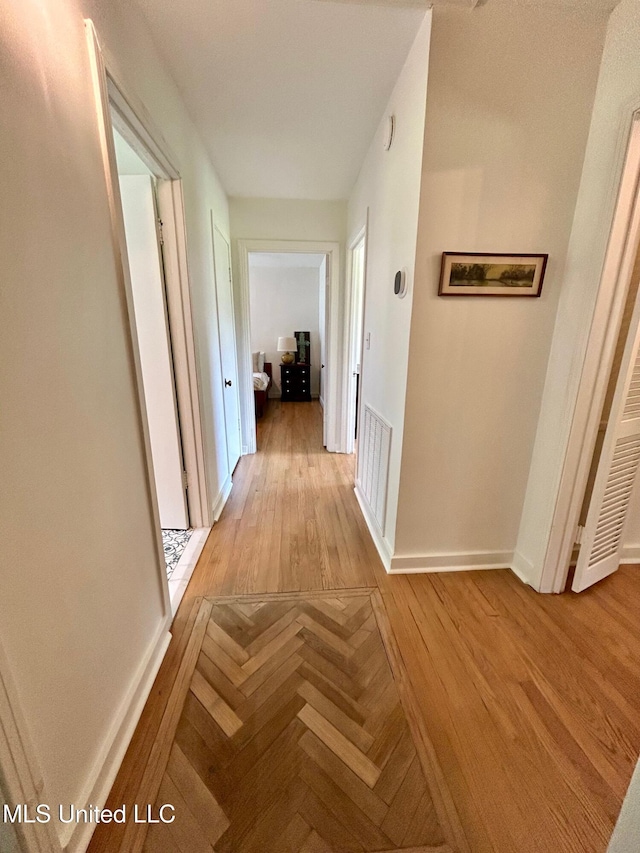 308 College St, Carthage, MS 39051 - corridor with baseboards, visible vents, and parquet floors