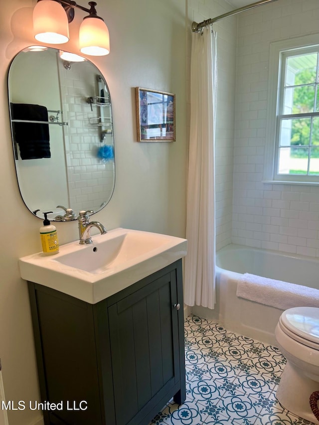 308 College St, Carthage, MS 39051 - bathroom featuring vanity, toilet, tile patterned flooring, and shower / bath combo with shower curtain