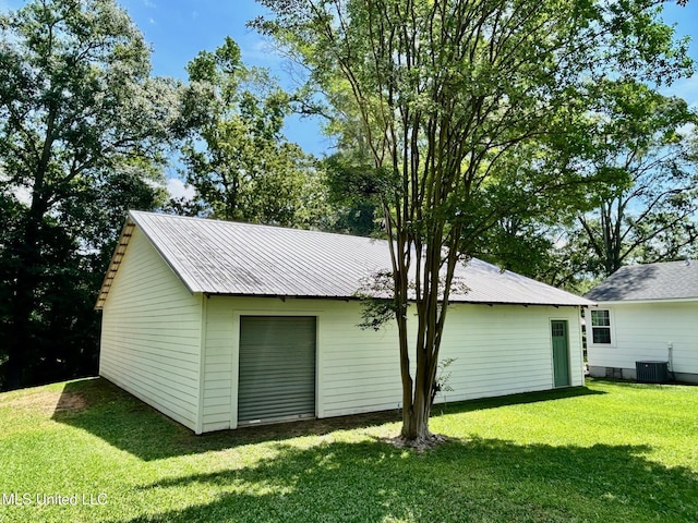 308 College St, Carthage, MS 39051 - exterior space featuring central air condition unit, a lawn, and metal roof