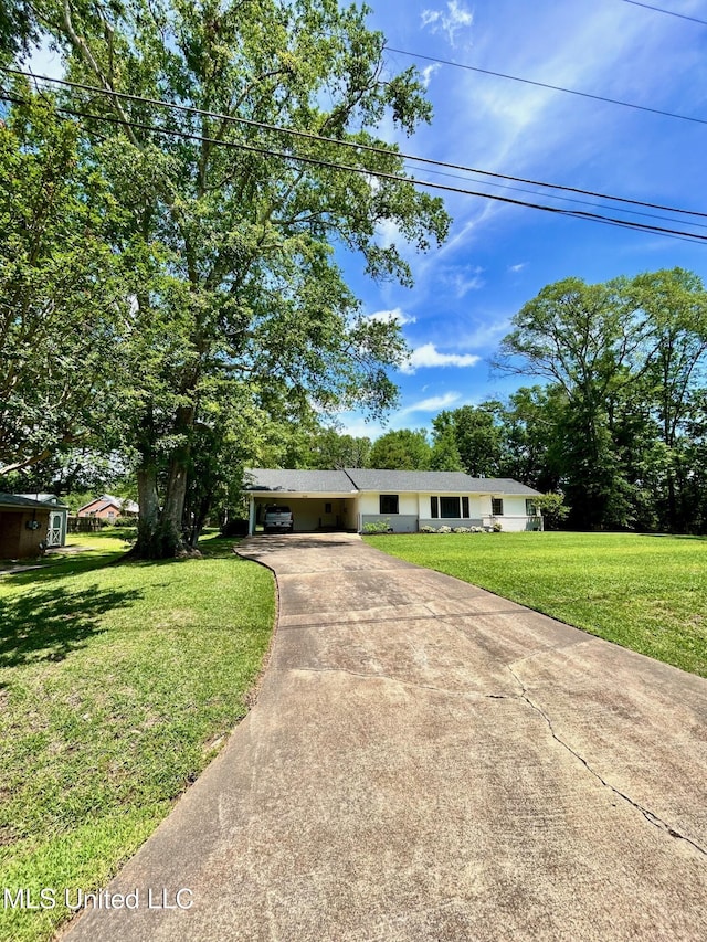 308 College St, Carthage, MS 39051 - ranch-style house featuring an attached carport, driveway, and a front lawn