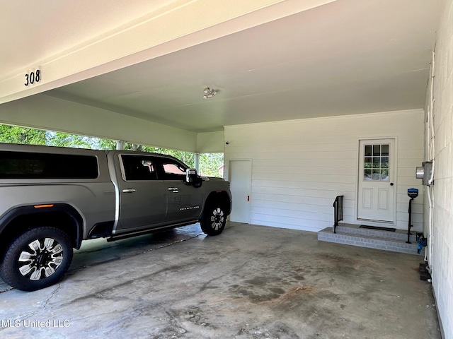 308 College St, Carthage, MS 39051 - garage featuring a carport