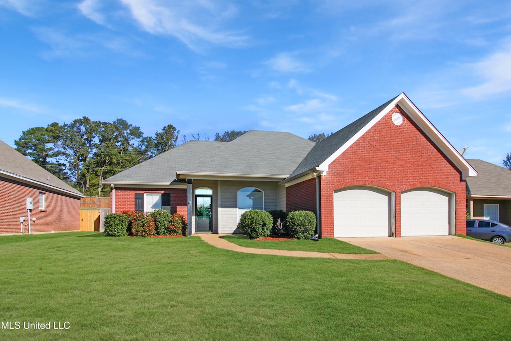 view of front of house with a front yard and a garage