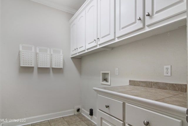 laundry area with hookup for a washing machine, light tile patterned flooring, cabinets, and ornamental molding