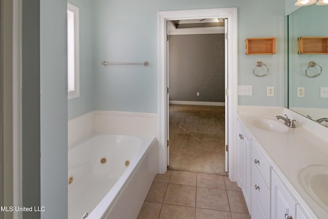 bathroom featuring tile patterned flooring, vanity, and a bath