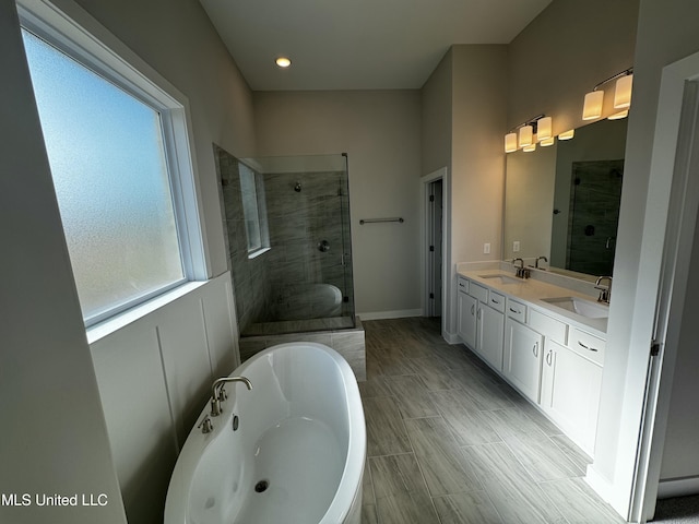 bathroom with vanity and independent shower and bath