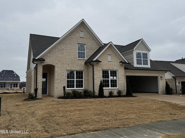 view of front of house with a garage and a front lawn