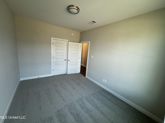 unfurnished bedroom featuring a closet and carpet floors