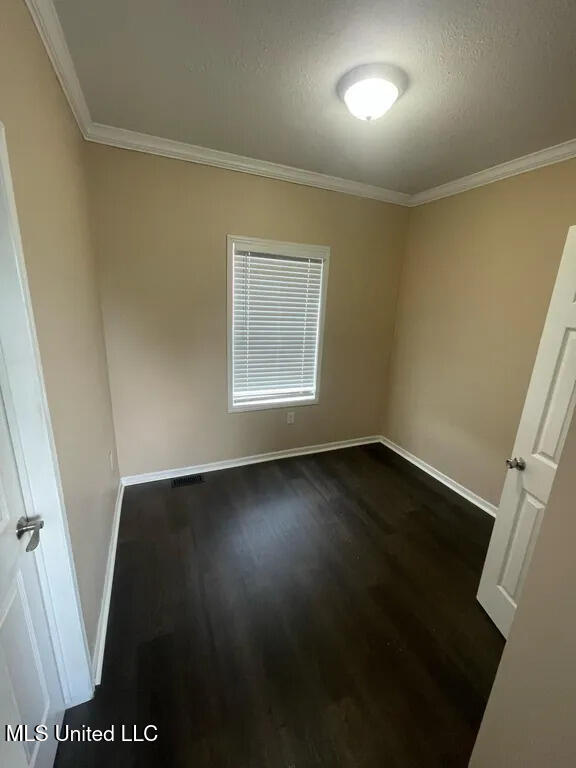 12205 Prudie Cir, Gulfport, MS 39503 - unfurnished room with dark wood finished floors, ornamental molding, and baseboards