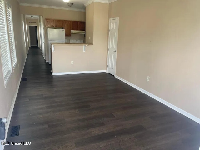 12205 Prudie Cir, Gulfport, MS 39503 - kitchen featuring ornamental molding, dark wood-style flooring, baseboards, freestanding refrigerator, and a peninsula