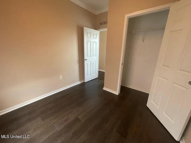 12205 Prudie Cir, Gulfport, MS 39503 - unfurnished bedroom featuring dark wood finished floors, a closet, and baseboards