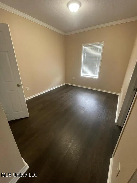 12205 Prudie Cir, Gulfport, MS 39503 - empty room with ornamental molding, dark wood-style flooring, and baseboards