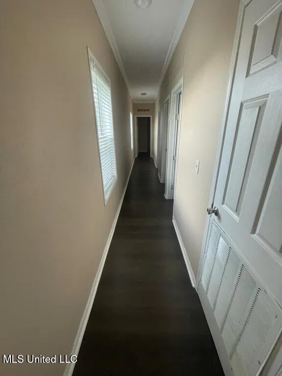 12205 Prudie Cir, Gulfport, MS 39503 - hallway featuring baseboards, dark wood-type flooring, and crown molding