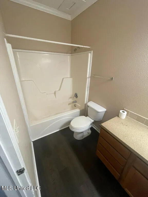 12205 Prudie Cir, Gulfport, MS 39503 - bathroom with washtub / shower combination, toilet, vanity, wood finished floors, and ornamental molding