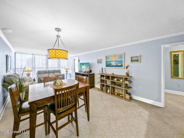 tiled dining area with ornamental molding and a textured ceiling