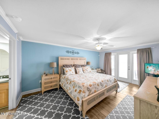 bedroom with sink, dark wood-type flooring, ceiling fan, ornamental molding, and access to outside