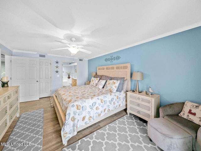 bedroom featuring crown molding, ceiling fan, and wood-type flooring