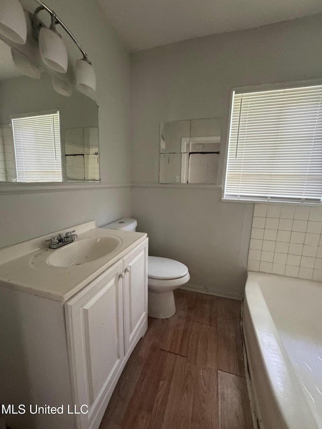 941 Dorgan St, Jackson, MS 39204 - full bathroom featuring wood finished floors, a tub, and vanity