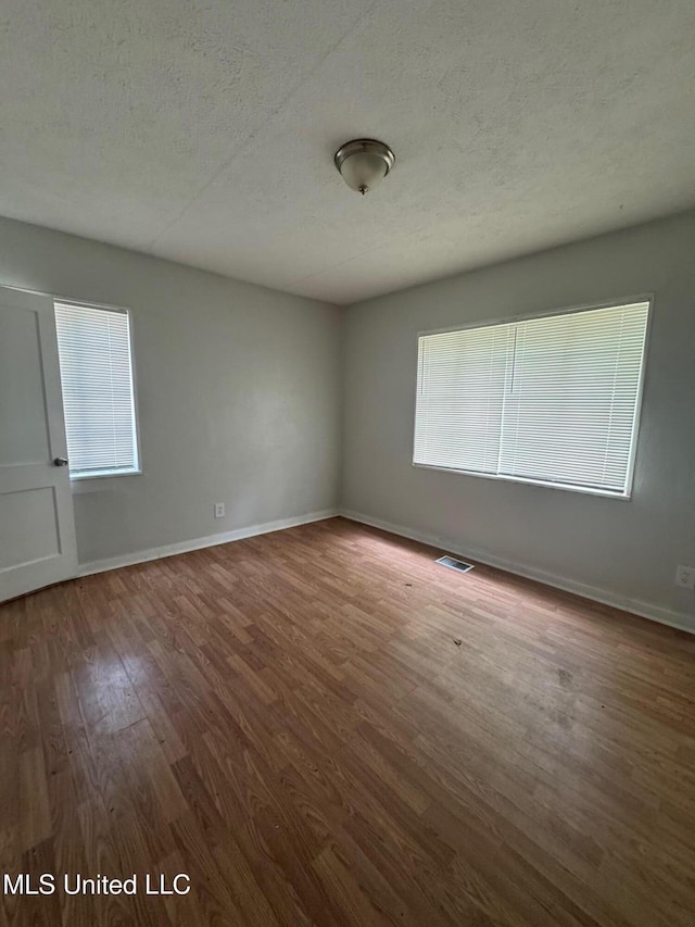 941 Dorgan St, Jackson, MS 39204 - empty room with a textured ceiling and wood finished floors
