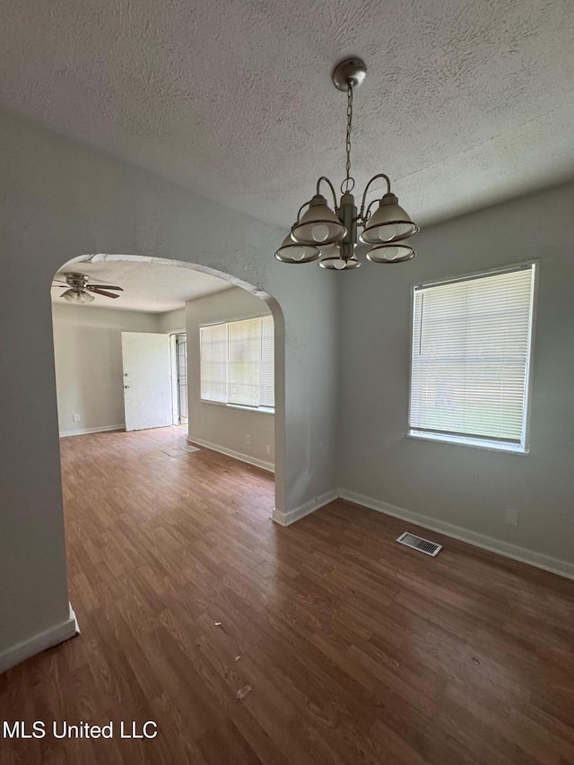 941 Dorgan St, Jackson, MS 39204 - spare room with arched walkways, a chandelier, wood finished floors, a textured ceiling, and a ceiling fan