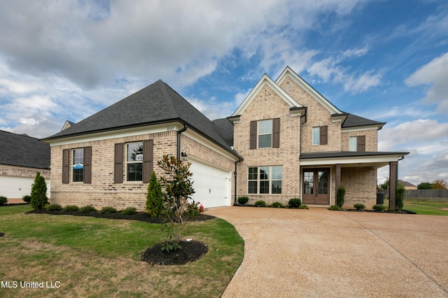 view of front of home featuring french doors, concrete driveway, brick siding, a garage, and a front yard