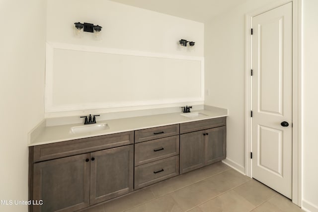 bathroom featuring tile patterned floors and a sink