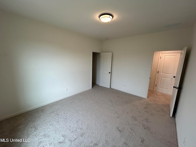 unfurnished bedroom featuring light colored carpet