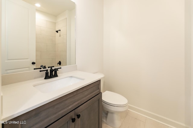 full bath with tile patterned floors, toilet, vanity, baseboards, and a shower
