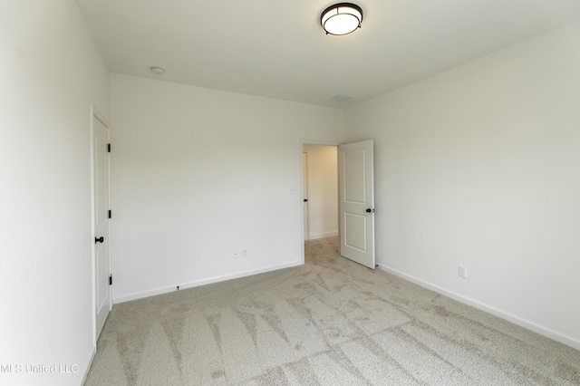 carpeted spare room with baseboards