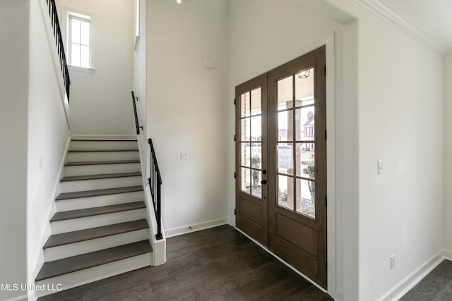 entrance foyer featuring crown molding, stairs, french doors, dark wood finished floors, and baseboards