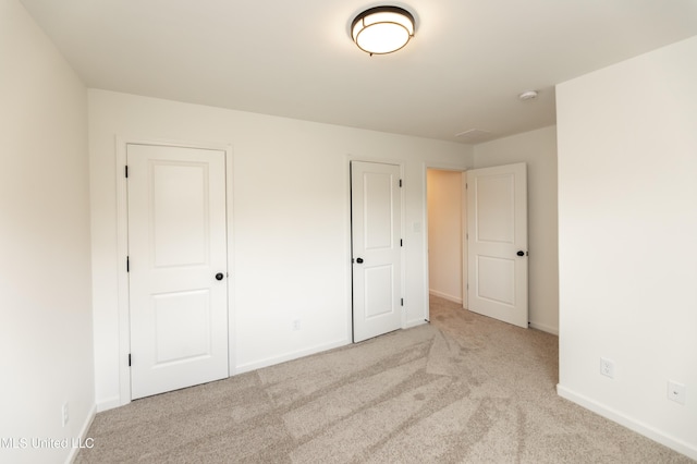 unfurnished bedroom featuring light colored carpet