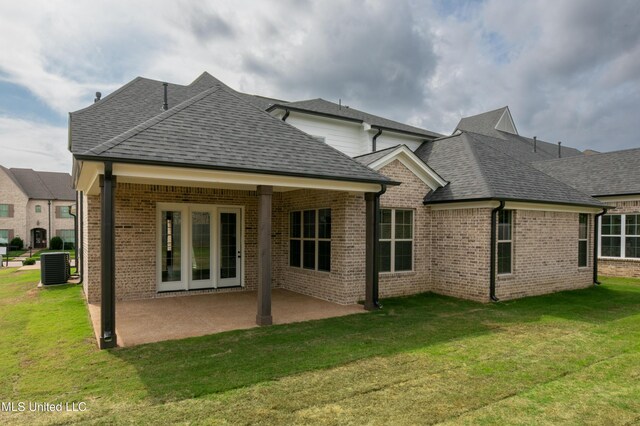 8042 Old Addison Dr, Olive Branch, MS 38654 - back of house featuring a shingled roof, a yard, brick siding, and a patio