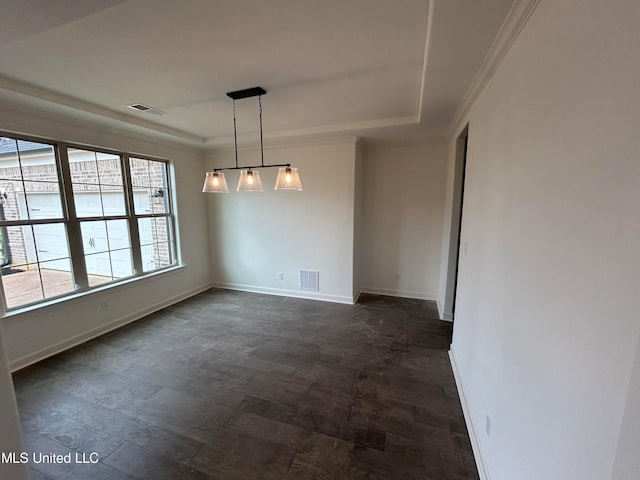 unfurnished dining area featuring a raised ceiling and crown molding