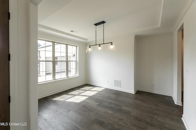 unfurnished dining area with dark wood finished floors, a raised ceiling, and visible vents