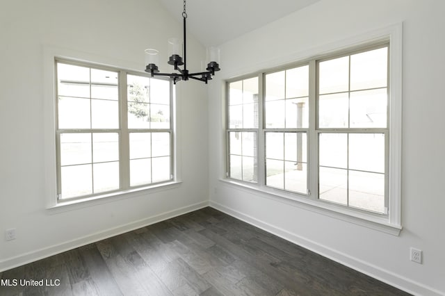 unfurnished dining area with lofted ceiling, baseboards, an inviting chandelier, and dark wood-type flooring