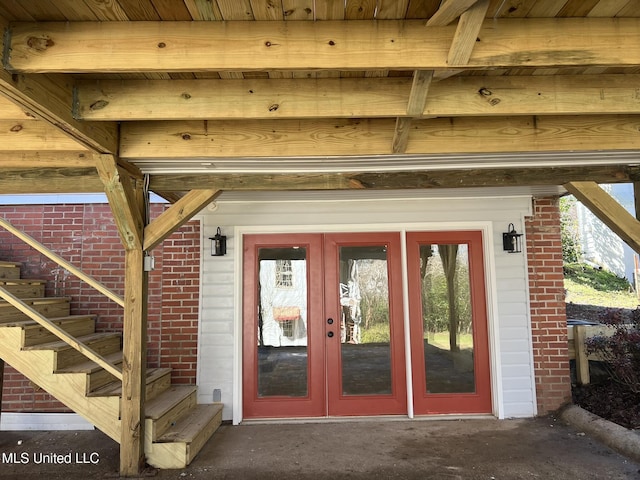 entrance to property featuring brick siding and french doors