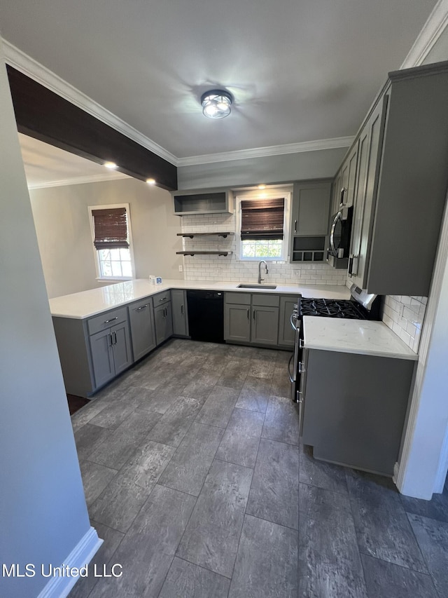 kitchen featuring stainless steel appliances, decorative backsplash, light countertops, and a sink