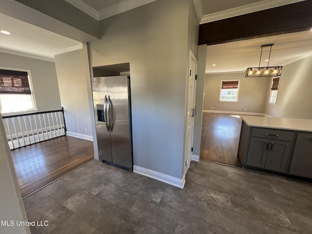 kitchen with stainless steel fridge with ice dispenser, ornamental molding, decorative light fixtures, light countertops, and gray cabinetry