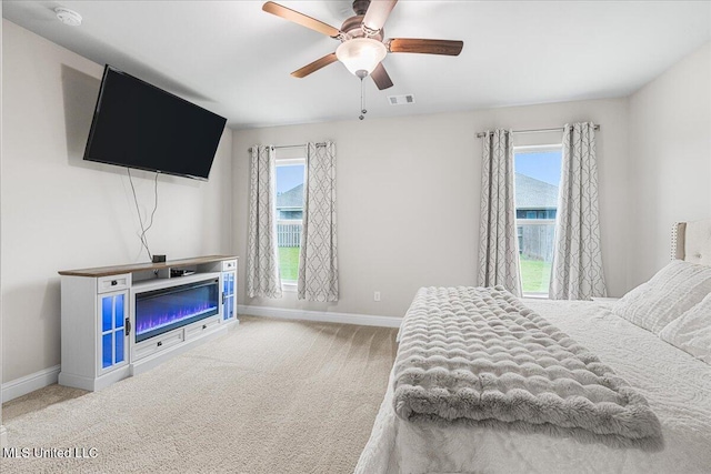 bedroom featuring baseboards, carpet floors, and a ceiling fan