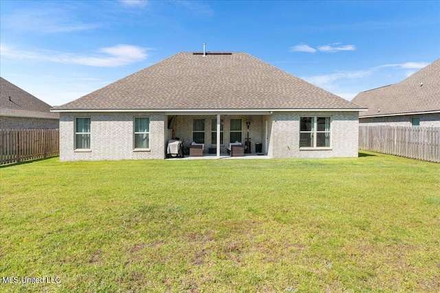 rear view of house with roof with shingles, a patio area, and brick siding